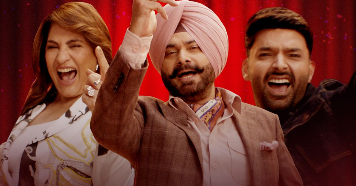 Navjot Singh Sidhu smiling and clapping on the set of The Great Indian Kapil Show with Kapil Sharma and Archana Puran Singh, during his grand return on Netflix.