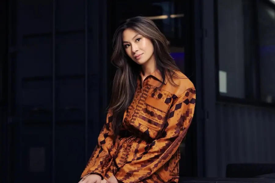 Lucy Guo, a self-made tech billionaire and co-founder of Scale AI, smiling confidently in a modern office setting, representing innovation, entrepreneurship, and female empowerment in the tech industry.